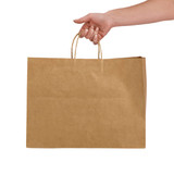 A hand holds an extra large brown paper bag with handles. The bag has a simple design and a visible logo.