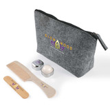 A grey cosmetic bag with a zipper, containing a wooden comb and two small containers. The bag features a logo. A grey cosmetic bag with a zipper, containing a wooden comb and two small containers. The bag features a logo.