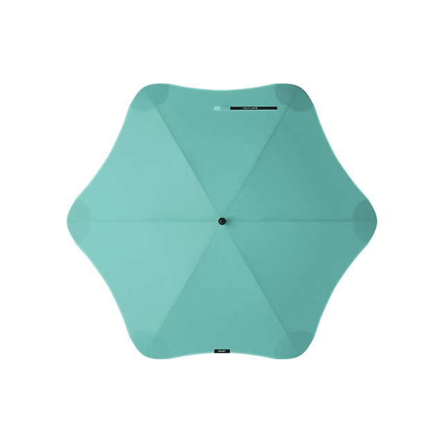 A mint green BLUNT Classic Umbrella with an octagonal shape and a central hub, featuring a logo.