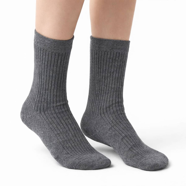 A pair of grey ribbed socks, shown from the ankle down on a person's feet. The socks appear soft and comfortable.