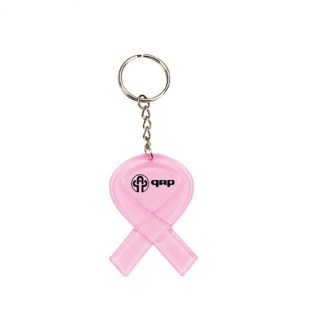 A pink key tag in the shape of a ribbon with a metal keyring and a logo.