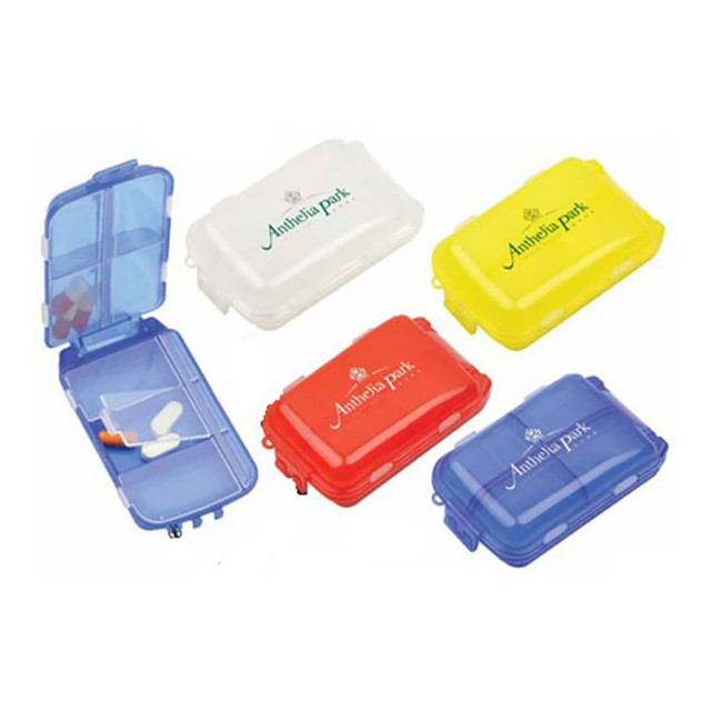 A set of five pill boxes in blue, white, red, yellow, and orange, featuring one with a clear lid displaying tablets inside.