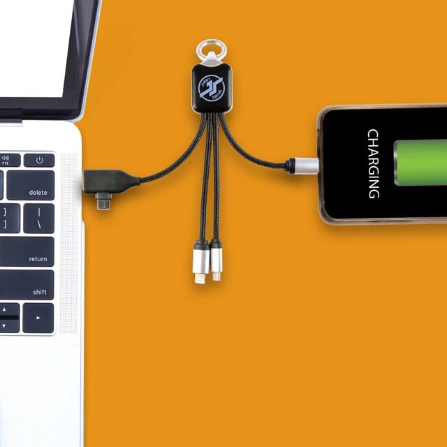 A Kinetic Square Glow Cable in black connects a laptop and a phone, with various charging tips included. A Kinetic Square Glow Cable in black connects a laptop and a phone, with various charging tips included.