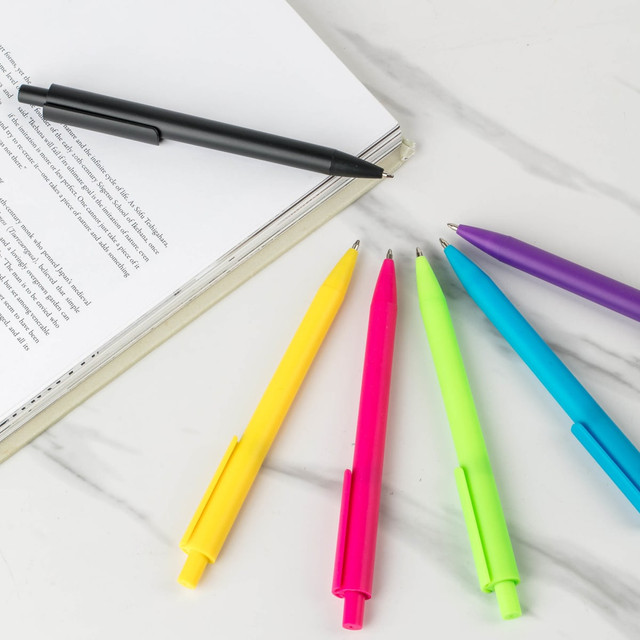 A collection of six plastic pens in black, yellow, pink, green, blue, and purple, rest near an open notebook. A collection of six plastic pens in black, yellow, pink, green, blue, and purple, rest near an open notebook.
