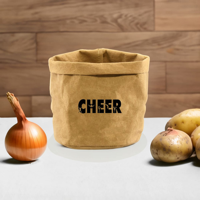 A kraft paper storage bag in tan, featuring a logo, next to an onion and several potatoes on a wooden surface. A kraft paper storage bag in tan, featuring a logo, next to an onion and several potatoes on a wooden surface.