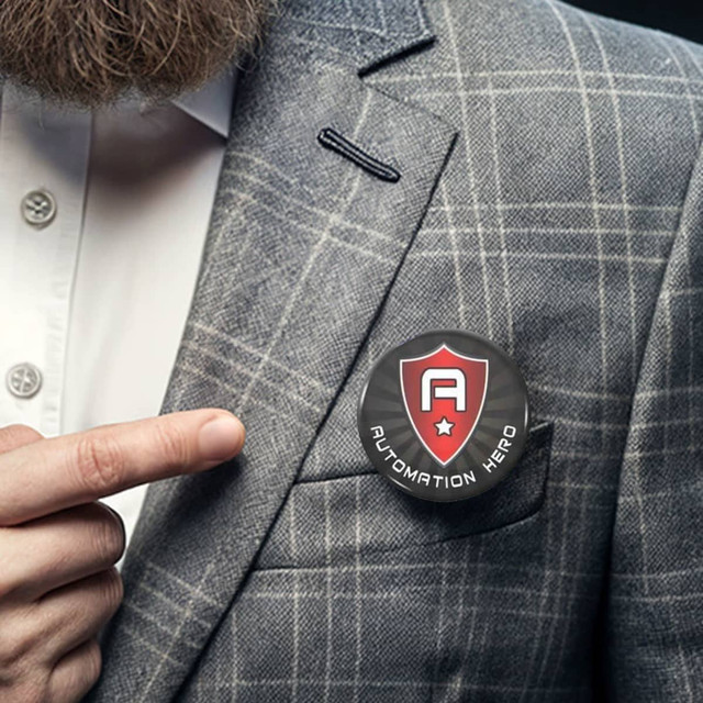 A round button badge, 44mm in size, featuring a shield design, pinned on a grey checked blazer.