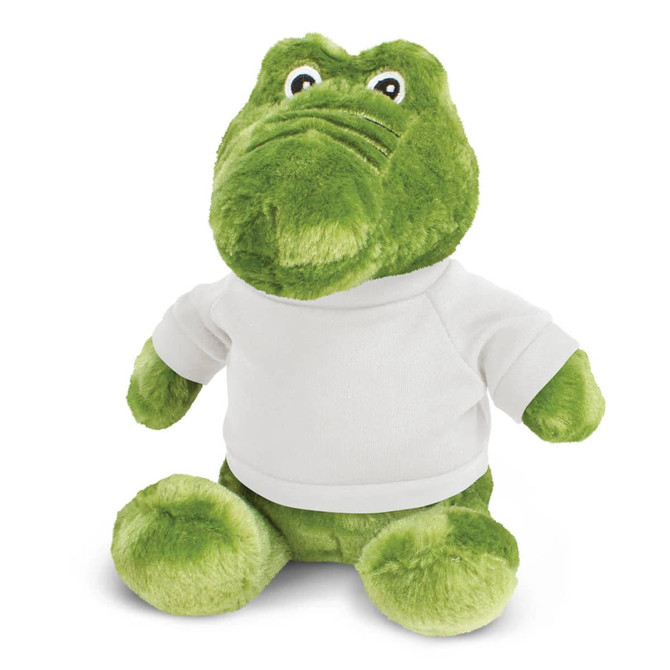 A green crocodile plush toy wearing a white shirt, featuring large eyes and a friendly expression.