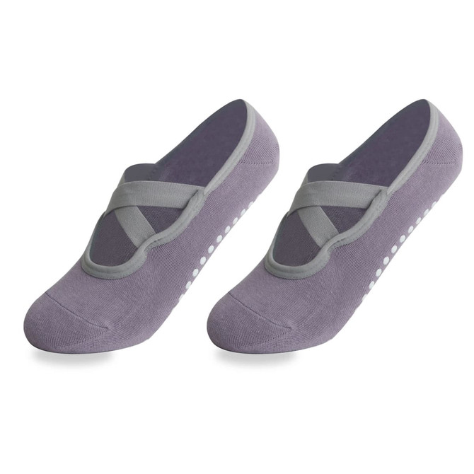 A pair of grey yoga socks featuring a crisscross design and non-slip grip dots on the soles.