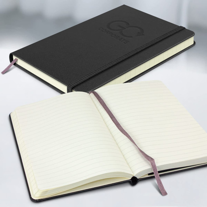 A black hardcover notebook with a branded logo, featuring lined pages and a ribbon bookmark, open and closed.