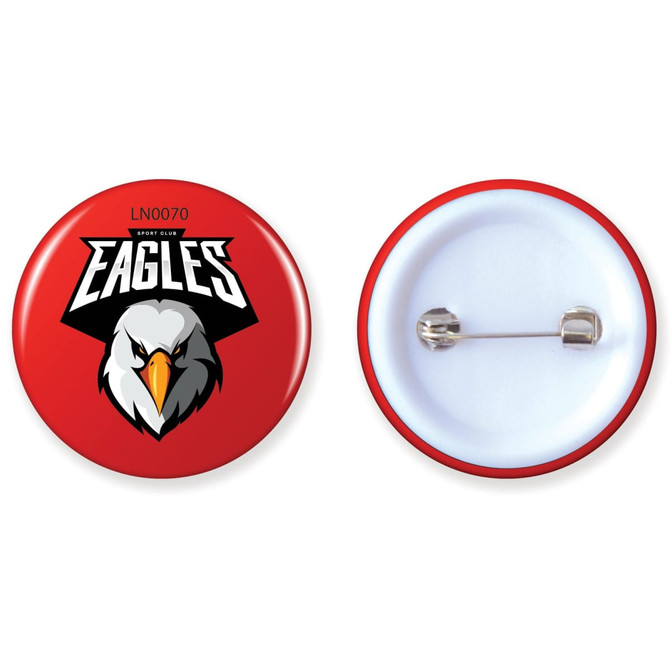 A red button badge featuring a logo with an eagle design and a silver pin on the back.