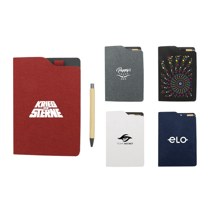 A selection of A5 notebooks in red, black, grey, white, and navy, alongside a beige pen. Each notebook features a logo.