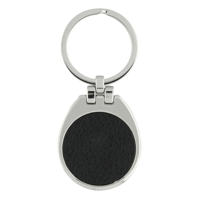 A silver keychain with a round black leather insert and a circular ring for attaching keys.