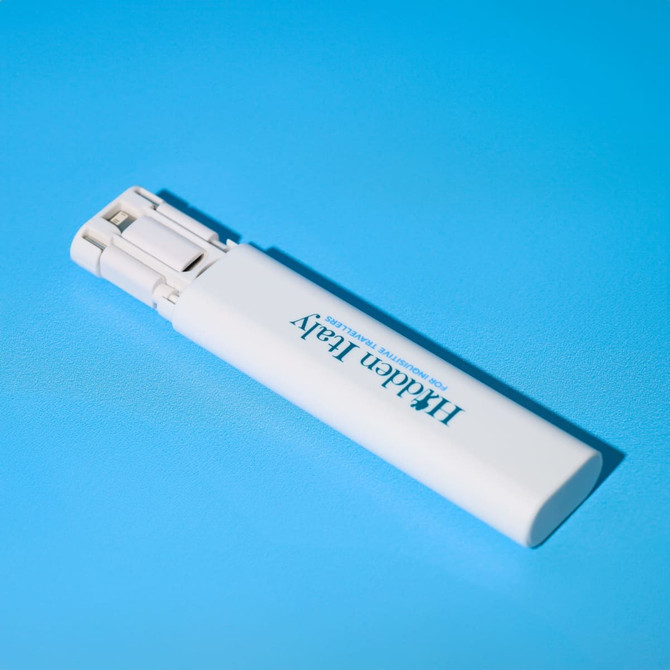 A white portable charger with a sleek design, featuring a logo and a smooth finish on a blue background.