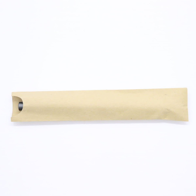 A cylindrical pen covered in brown paper packaging, featuring a metallic tip, and a visible opening.