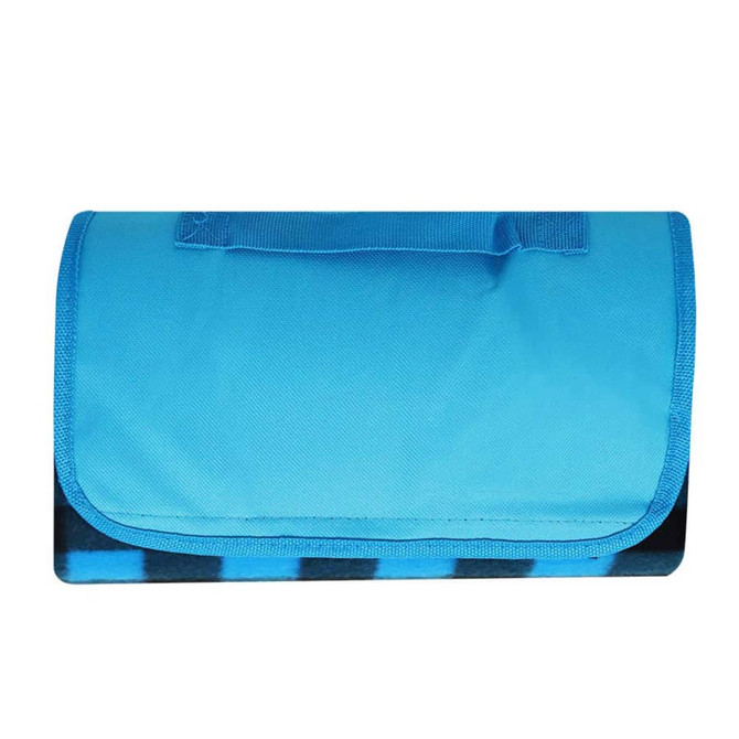 A blue picnic blanket with a foldable design and a handle for easy transport. It features a black and blue patterned underside.