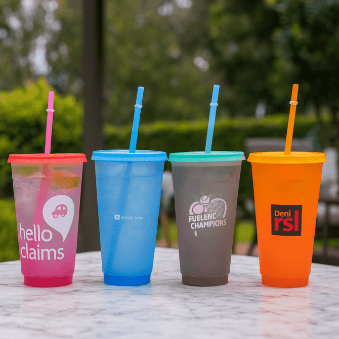 A drink bottle display featuring four colourful plastic cups with straws: pink, blue, green, grey, and orange.