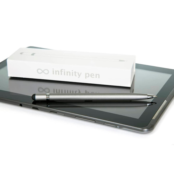 A silver metal pen rests on a tablet, next to its white packaging featuring a logo.