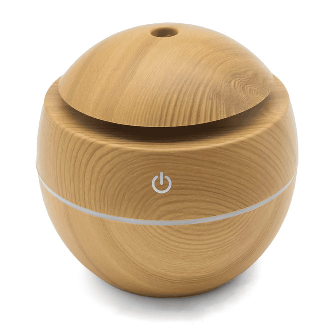 A round wooden diffuser in a light timber finish with a circular design and a power button.