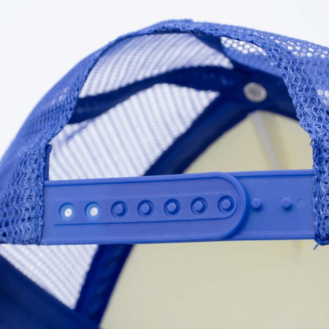 A blue trucker cap featuring a mesh back and an adjustable plastic strap for sizing. The cap has a logo.