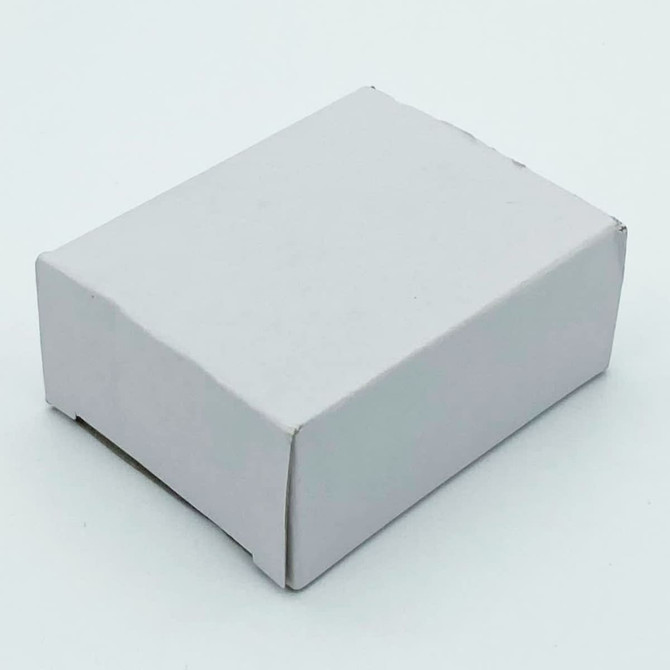 A small white cardboard box with a plain design, likely containing dental floss products.