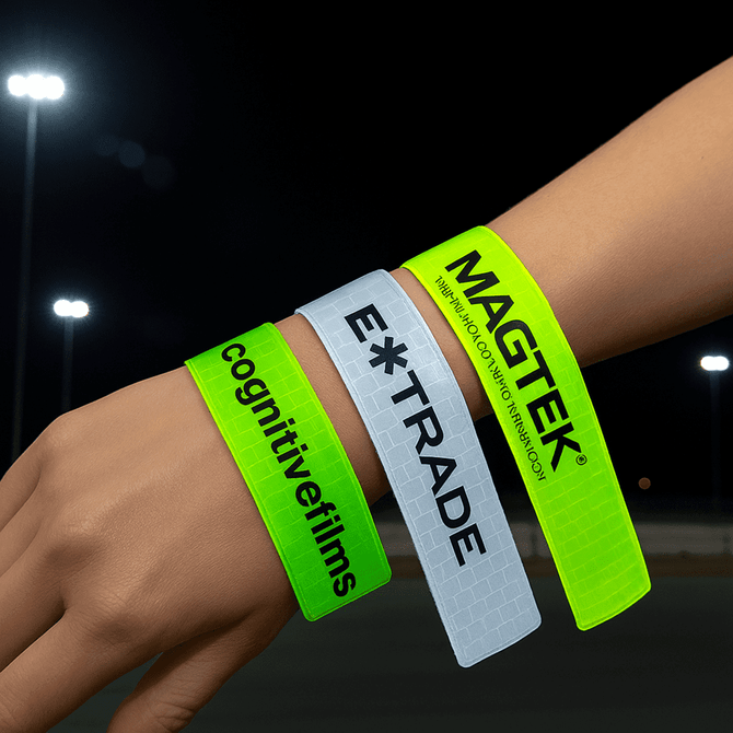 A hand featuring three reflective slap wristbands in neon green and yellow, each with different logos.