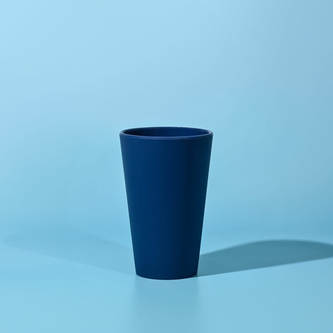A drink bottle in a deep navy blue colour with a simple design and a smooth surface. It features a logo.