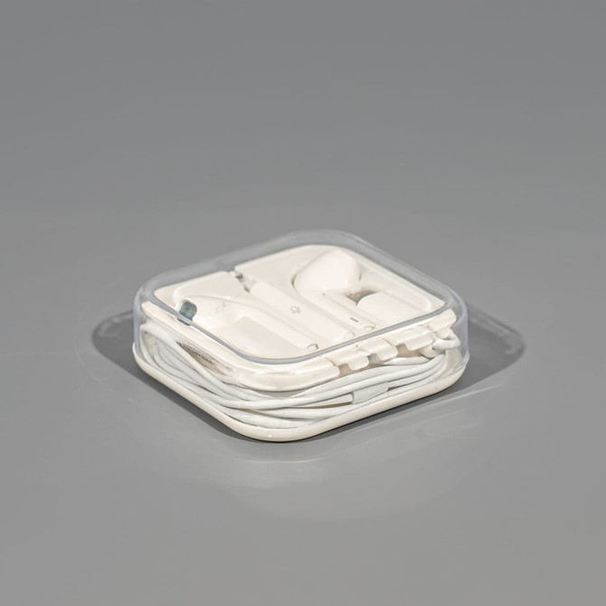 A set of white USB Type C earphones, neatly packaged in a transparent case.