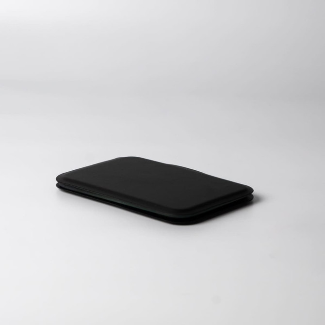 A black pocket mirror with a slim, rectangular design, featuring a soft-touch finish and minimalistic look.