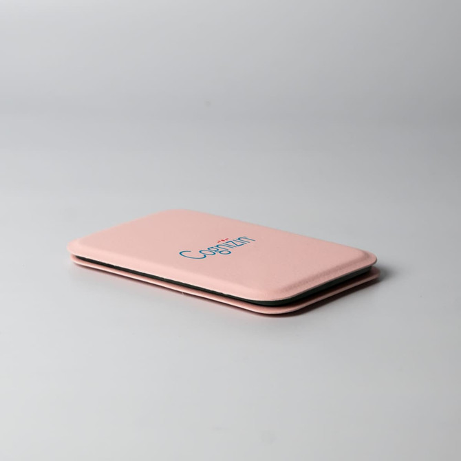 A pink pocket mirror with a slim and rectangular design, featuring a logo on the front.