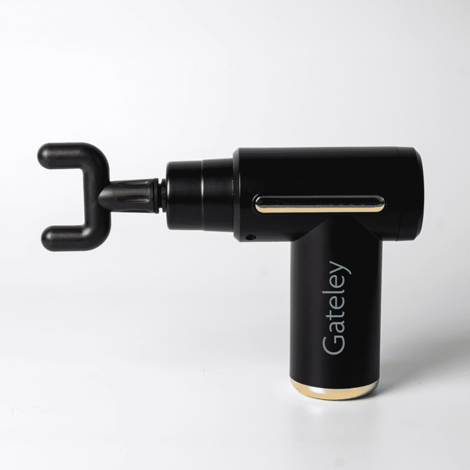 A black massage gun with a unique hook attachment, featuring a branded logo and a sleek design.