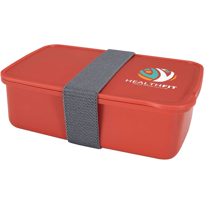 A red lunch box with a grey strap and a logo on the side, featuring a rectangular design.
