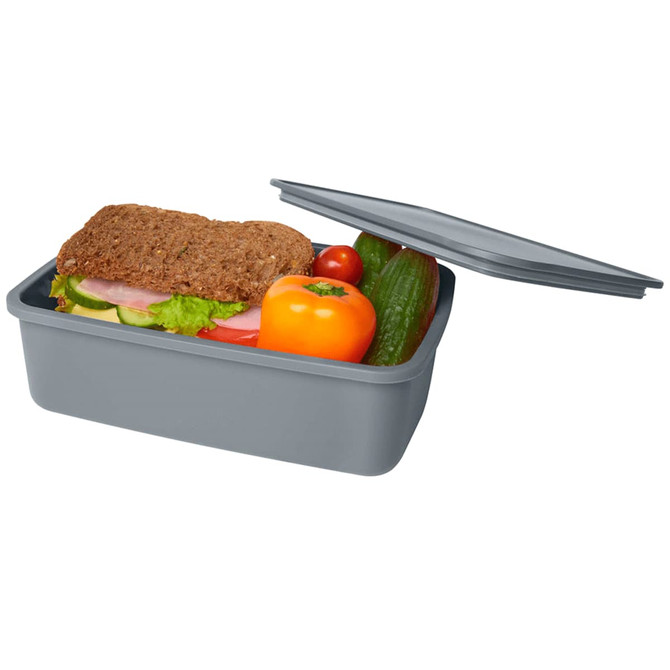 A grey lunch box containing a sandwich, tomato, cucumber, and bell pepper, with a lid partially open.