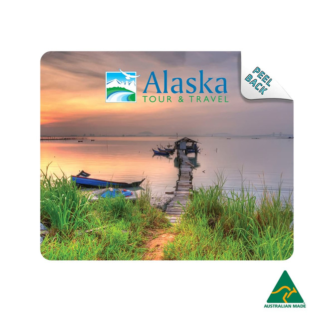 A mouse mat featuring a scenic image of a pier at sunset, with greenery and boats, showcasing blue and earthy tones.