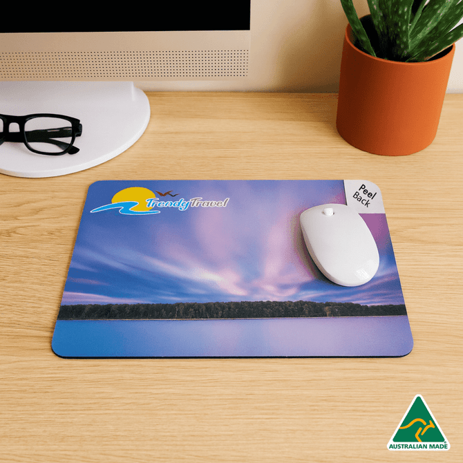 A mouse mat featuring a vibrant sunset design in shades of purple and blue, with a white mouse and a logo.