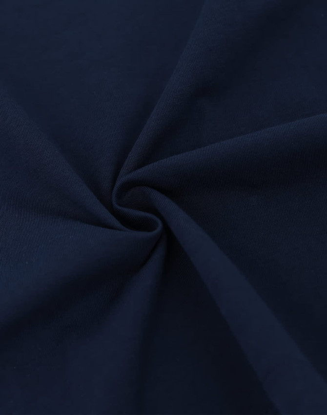 A close-up of navy cotton fabric, highlighting its soft texture and smooth finish. The fabric is suitable for T-shirts.
