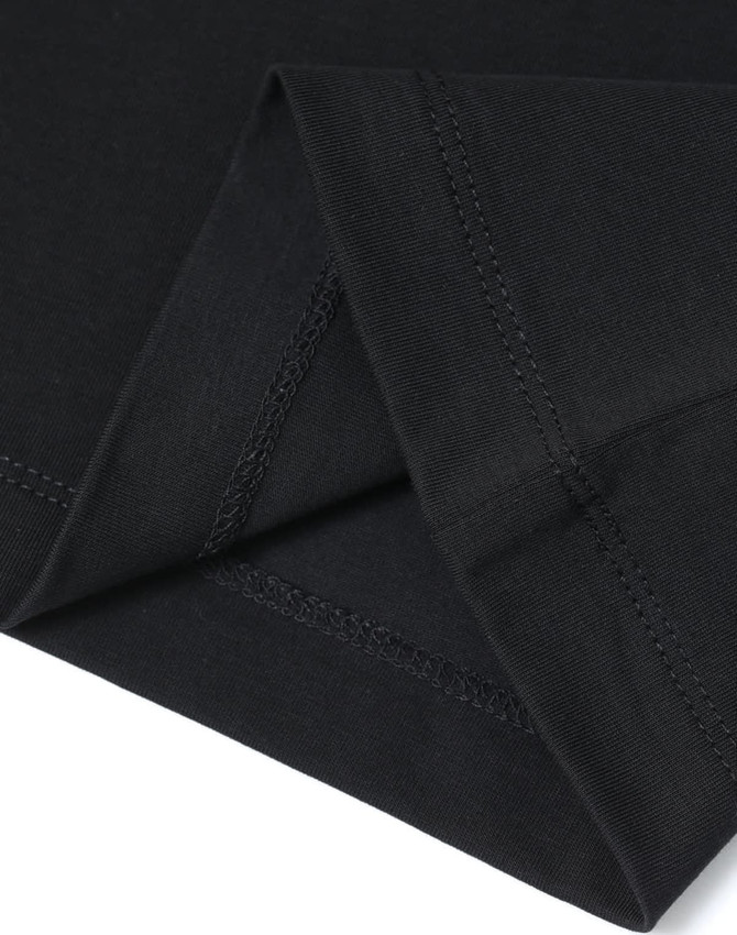 A close-up of a black premium cotton t-shirt, highlighting the fabric and stitching details.