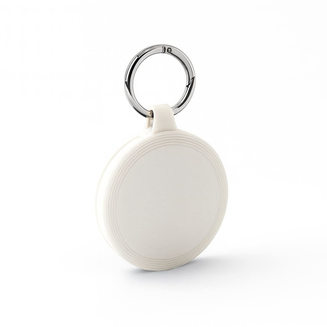 A white keychain with a circular design and a silver metal ring. The keychain features a subtle textured pattern.
