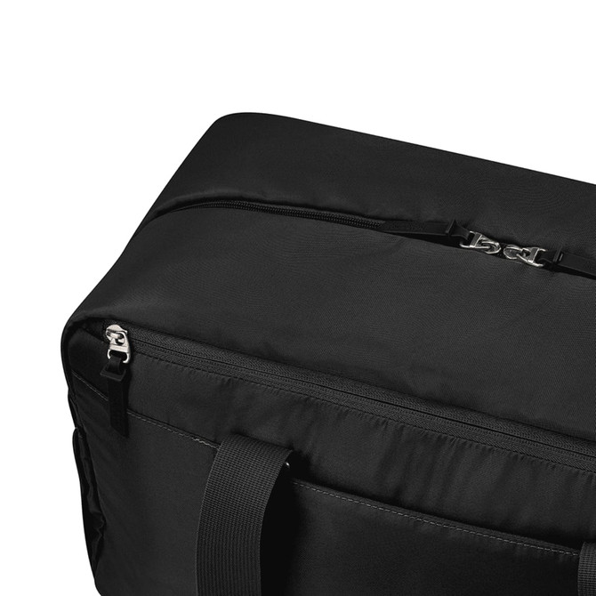 A black duffle bag featuring a zip closure and sturdy handles, with a logo present on the design.