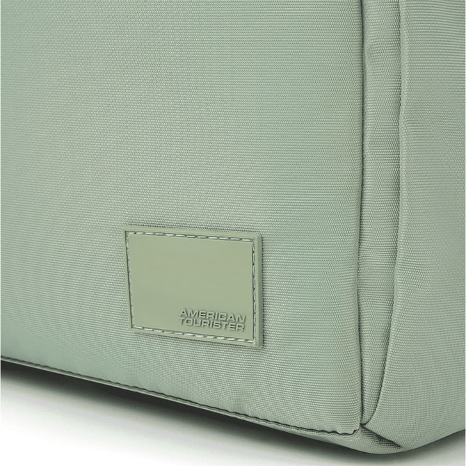 A green duffle bag featuring a textured surface and a subtle branding label.