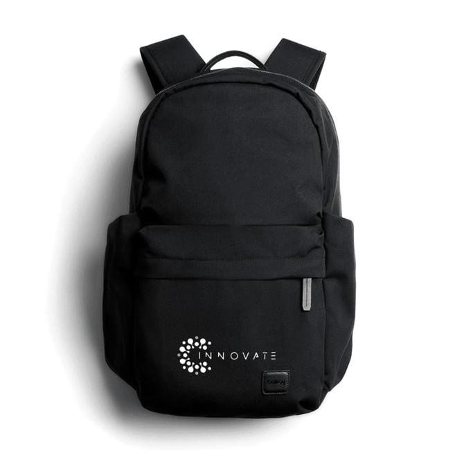 A black backpack with a logo on the front, featuring adjustable shoulder straps and a zippered pocket.