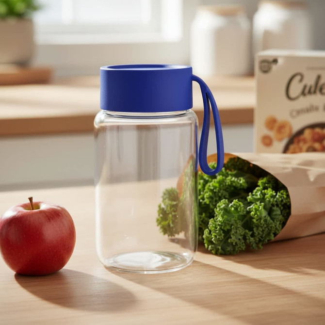 A drink bottle with a clear body and a blue lid, featuring a carrying handle, placed on a wooden surface.
