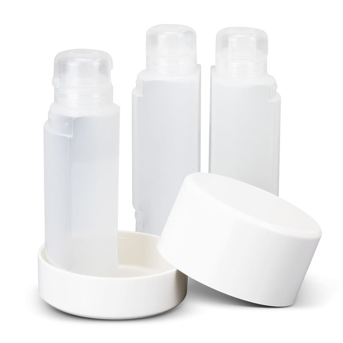A travel bottle set featuring three clear bottles with white lids and a white base.