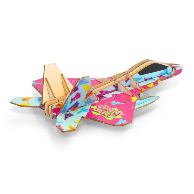 A wooden model of a jet fighter in vibrant pink and blue with colourful patterns, featuring a logo.