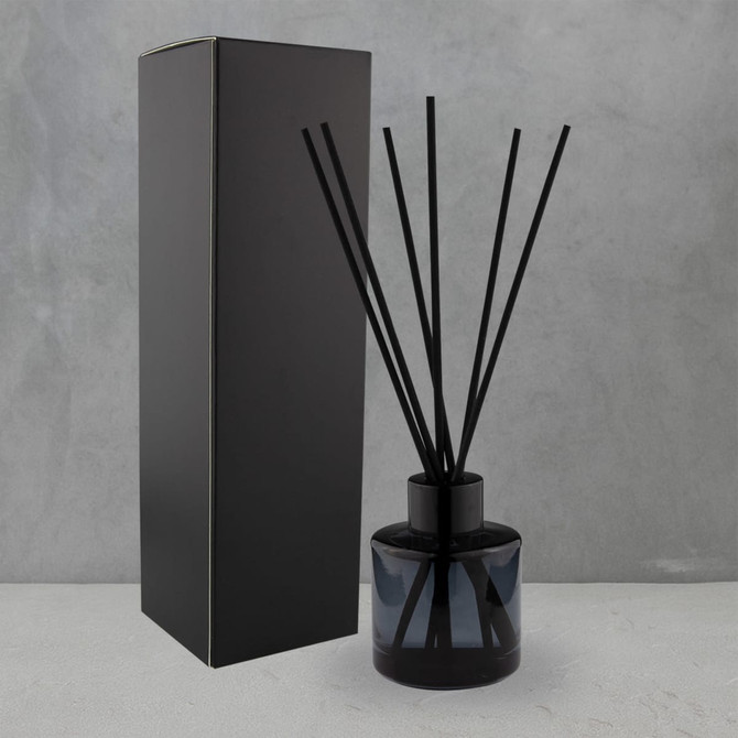 A round, 50ml black reed diffuser with five black sticks, presented beside a sleek black box.