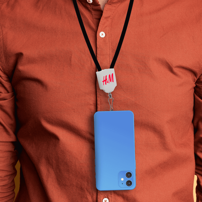 A blue phone is hanging from a black lanyard worn around a person's neck, featuring a logo at the top.