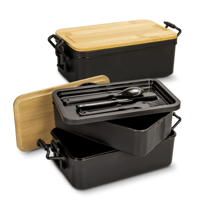 An expandable lunch box in black with a bamboo lid, featuring compartments and utensils inside. It has a logo.