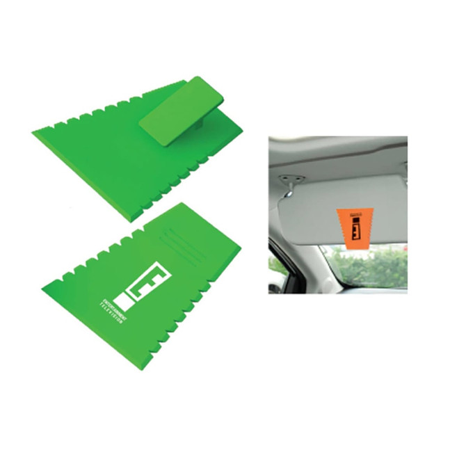 A green ice scraper tool with a textured edge and a hanging feature, alongside an orange accessory.