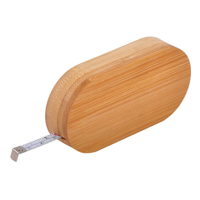 A bamboo bottle opener with a silver tape measure protruding from one end and a smooth, rounded design.