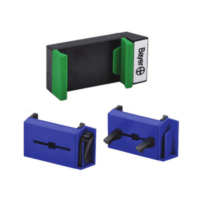 A car phone holder in black and green, with two blue clips, designed for secure phone placement.