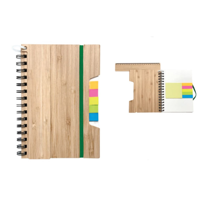 A5 notebook with a bamboo effect cover, green elastic band, and colourful sticky notes. It features a spiral binding.